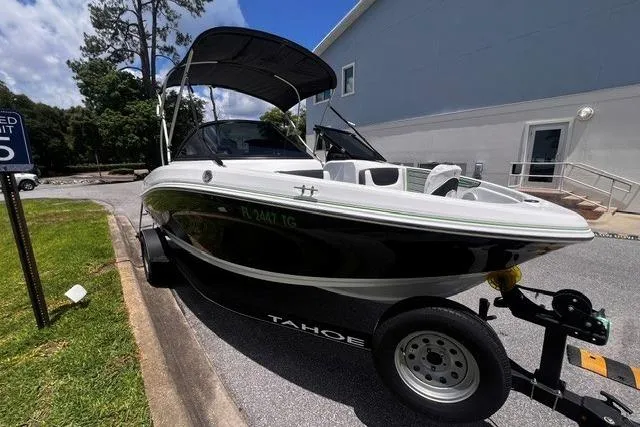 The Image of 2022 Tahoe 185 S boat on trailer, parked outdoors near a building. - 0
