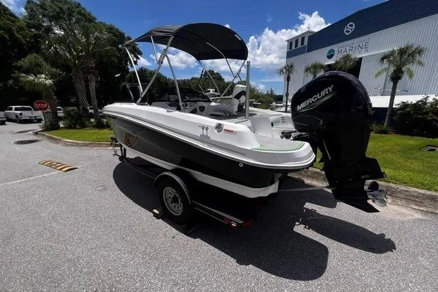 Slide: The Image of 2022 Tahoe 185 S boat with Mercury engine on trailer, parked outdoors. - 1
