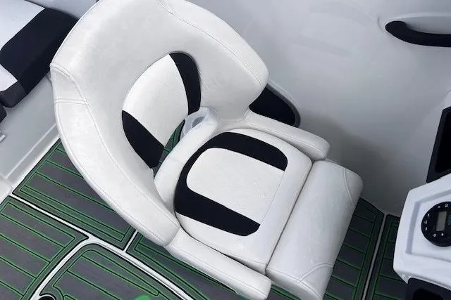 Slide: The Image of White and black boat seat in 2022 Tahoe 185 S, with green and gray flooring. - 10