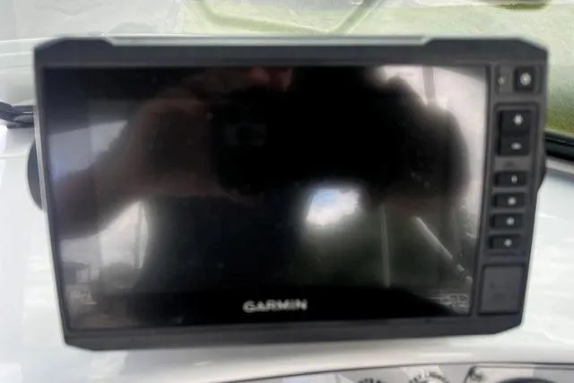 Slide: The Image of Garmin GPS device on a 2022 Tahoe 185 S dashboard, reflecting surroundings. - 12