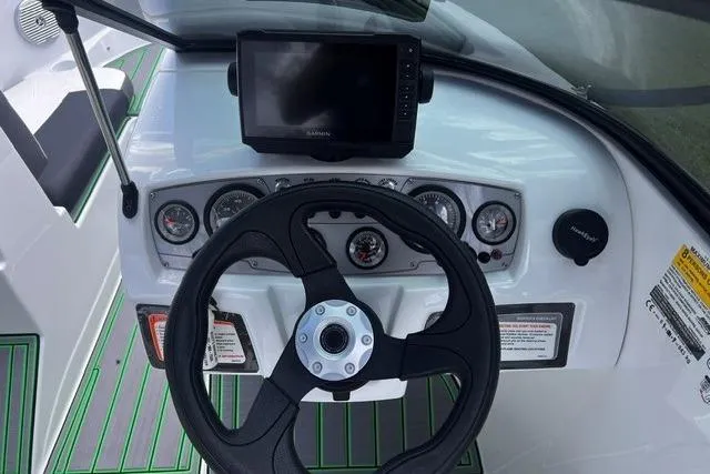 Slide: The Image of Steering console of 2022 Tahoe 185 S boat with gauges and navigation screen. - 13