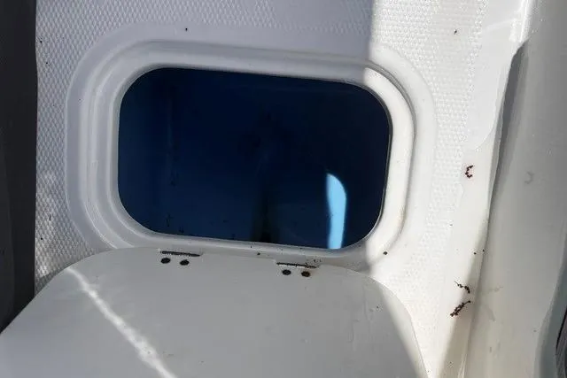 Slide: The Image of Open hatch on a 2022 Tahoe 185 S boat, showing interior compartment. - 17