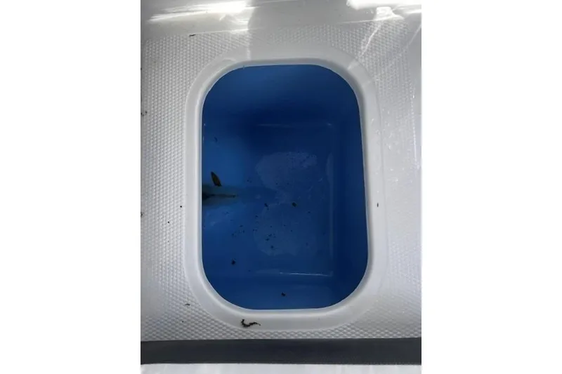 Slide: The Image of Livewell compartment in 2022 Tahoe 185 S boat, featuring a blue interior. - 18