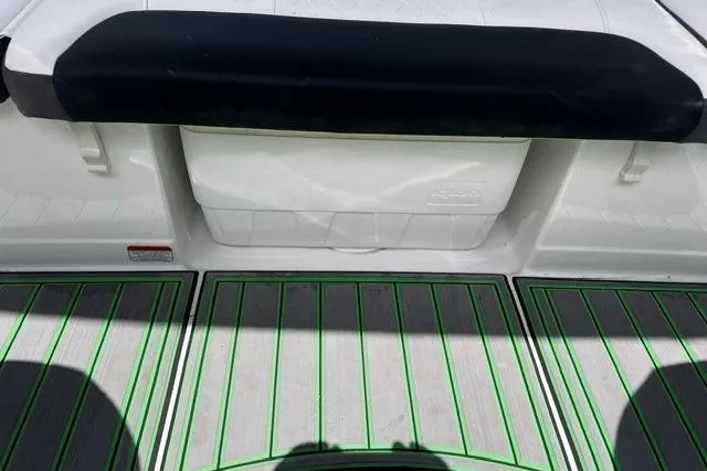 Slide: The Image of 2022 Tahoe 185 S boat interior with green-striped flooring and cushioned seating. - 19