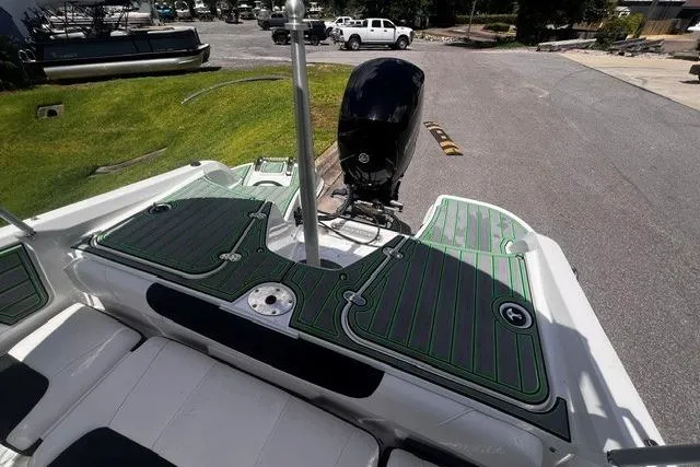 Slide: The Image of 2022 Tahoe 185 S boat with green deck, outboard motor, and white seating. - 20
