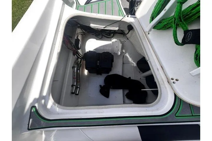 Slide: The Image of Open storage compartment in 2022 Tahoe 185 S boat, featuring wiring and equipment. - 21