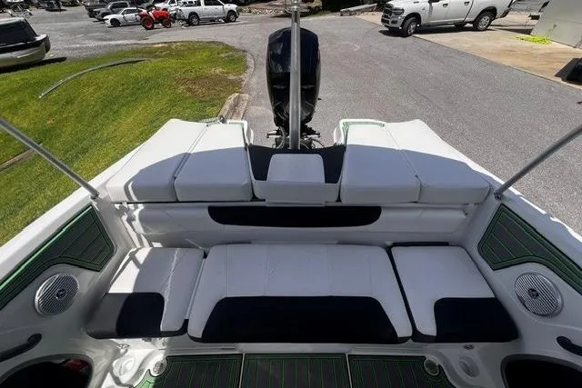 Slide: The Image of 2022 Tahoe 185 S boat interior with white and black seating, parked outdoors. - 23