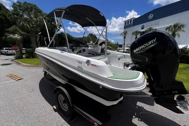 Slide: The Image of 2022 Tahoe 185 S boat with Mercury engine on trailer, parked outdoors. - 3