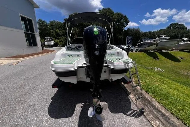 Slide: The Image of 2022 Tahoe 185 S boat with outboard motor, parked on a sunny day near other boats. - 4