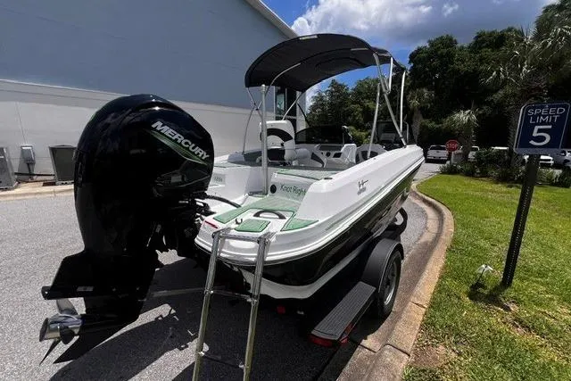 Slide: The Image of 2022 Tahoe 185 S boat with Mercury engine on trailer, parked near speed limit sign. - 5