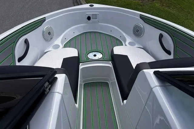 Slide: The Image of 2022 Tahoe 185 S boat interior with green-accented seating and speakers. - 6