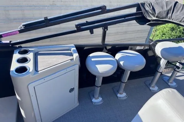 Slide: The Image of 2022 Sylvan L3 DLZ Bar boat interior with bar stools and cup holders. - 11