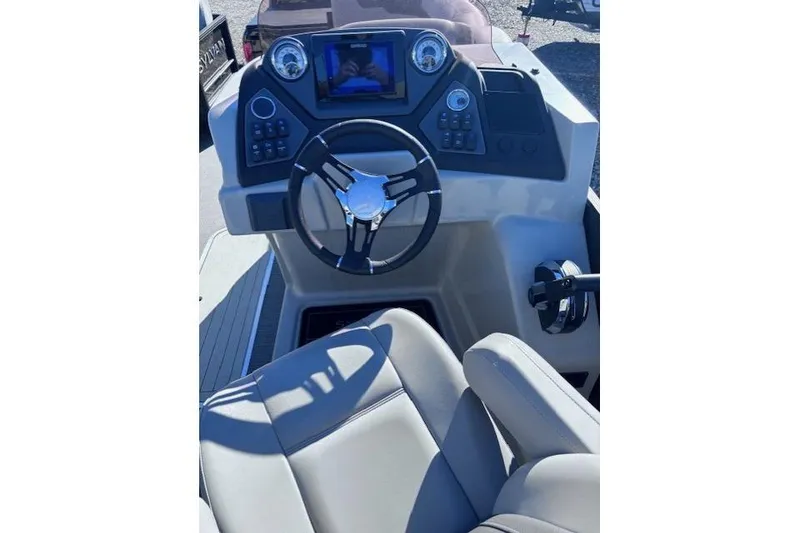 Slide: The Image of 2022 Sylvan L3 DLZ Bar boat dashboard with steering wheel and controls. - 3