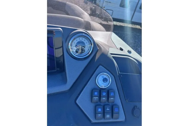 Slide: The Image of Dashboard of 2022 Sylvan L3 DLZ Bar boat with gauges and control buttons. - 5