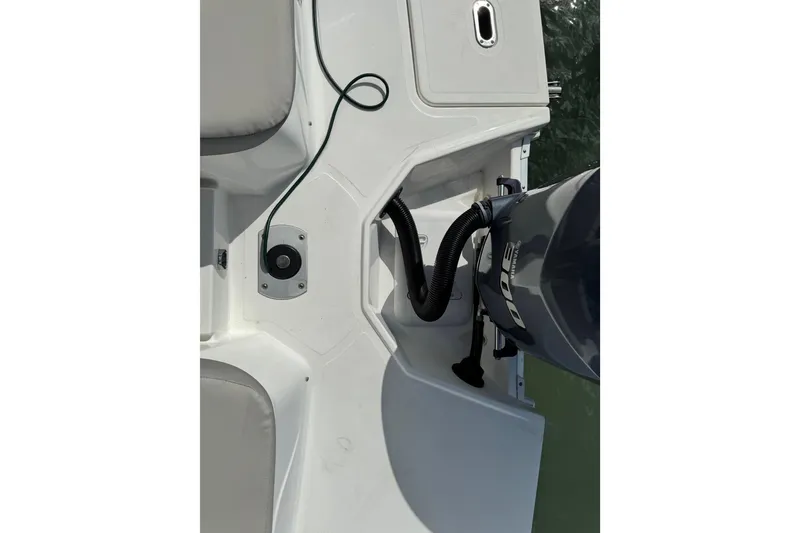 Slide: The Image of 2023 Hurricane SunDeck 2600 OB boat deck with outboard motor and seating area. - 13