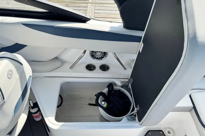 Slide: The Image of 2023 Hurricane SunDeck 2600 OB boat interior storage compartment with bucket and rope. - 14