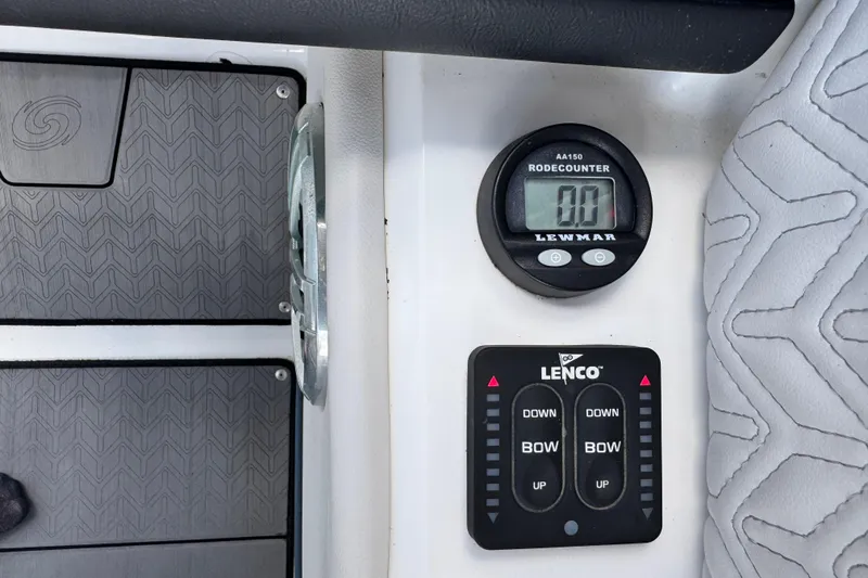 Slide: The Image of Control panel of 2023 Hurricane SunDeck 2600 OB with Lewmar rode counter and Lenco trim tab switches. - 15
