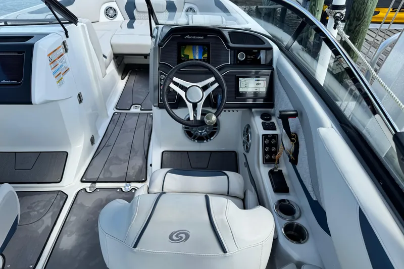 Slide: The Image of 2023 Hurricane SunDeck 2600 OB boat interior with modern dashboard and steering wheel. - 16
