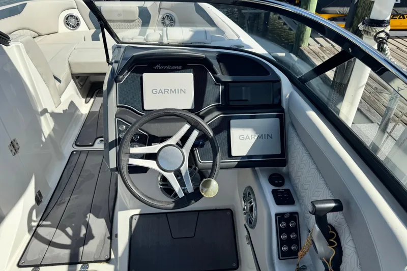 Slide: The Image of 2023 Hurricane SunDeck 2600 OB boat cockpit with Garmin navigation system. - 2
