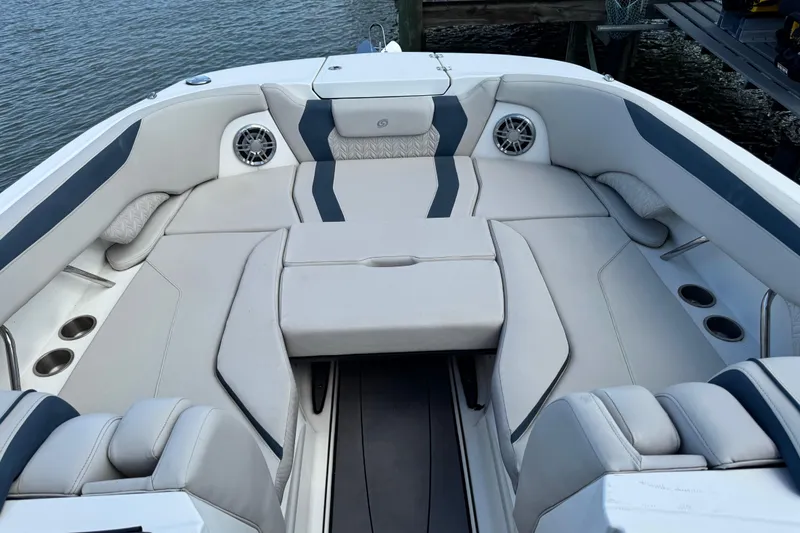Slide: The Image of 2023 Hurricane SunDeck 2600 OB boat interior with spacious seating and cup holders. - 20