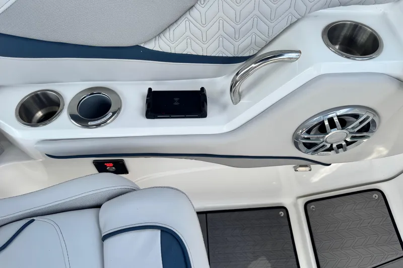 Slide: The Image of 2023 Hurricane SunDeck 2600 OB interior with cup holders, speaker, and phone holder. - 25