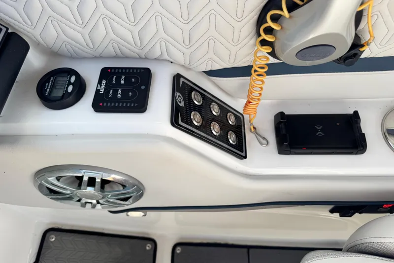 Slide: The Image of Control panel of 2023 Hurricane SunDeck 2600 OB boat with speaker and wireless charger. - 26