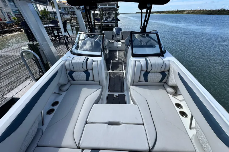 Slide: The Image of 2023 Hurricane SunDeck 2600 OB boat interior with plush seating and waterfront view. - 3