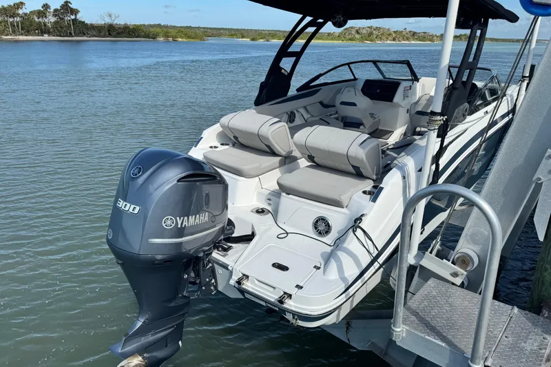 Slide: The Image of 2023 Hurricane SunDeck 2600 OB boat with Yamaha 300 engine docked on water. - 33