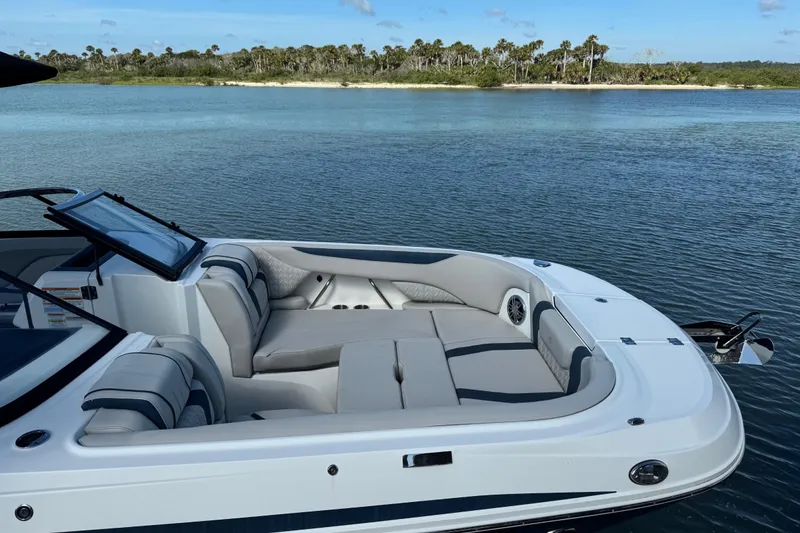 Slide: The Image of 2023 Hurricane SunDeck 2600 OB boat with spacious seating on calm water. - 34