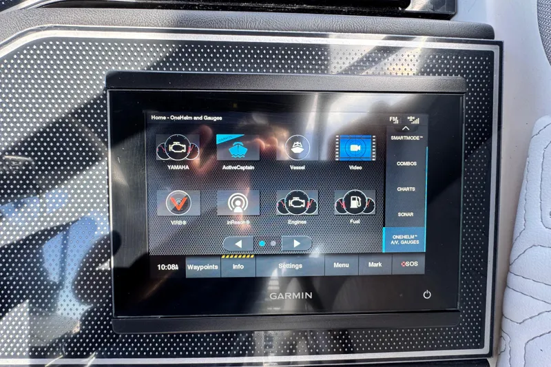 Slide: The Image of Garmin display on 2023 Hurricane SunDeck 2600 OB boat dashboard showing navigation and engine controls. - 4