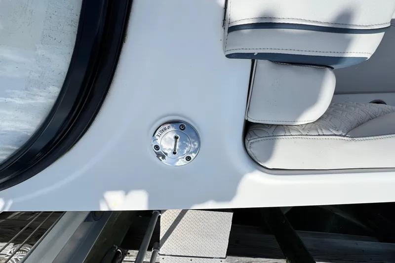 Slide: The Image of 2023 Hurricane SunDeck 2600 OB boat interior with white seating and waste disposal port. - 6