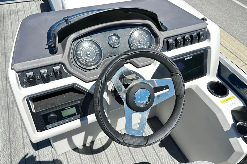 Slide: The Image of Steering console of 2023 Godfrey Sweetwater 2286 SB boat with modern controls and gauges. - 4