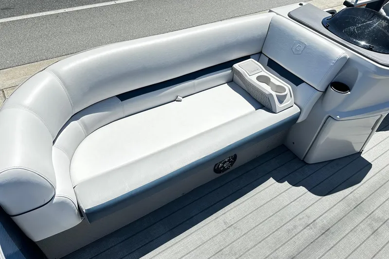 Slide: The Image of 2023 Godfrey Sweetwater 2286 SB boat interior with gray seating and cup holders. - 7