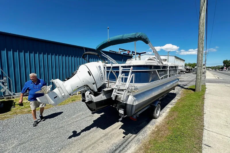 Slide: The Image of 2023 Godfrey Sweetwater 2286 SB pontoon boat with Suzuki outboard motor on trailer. - 8
