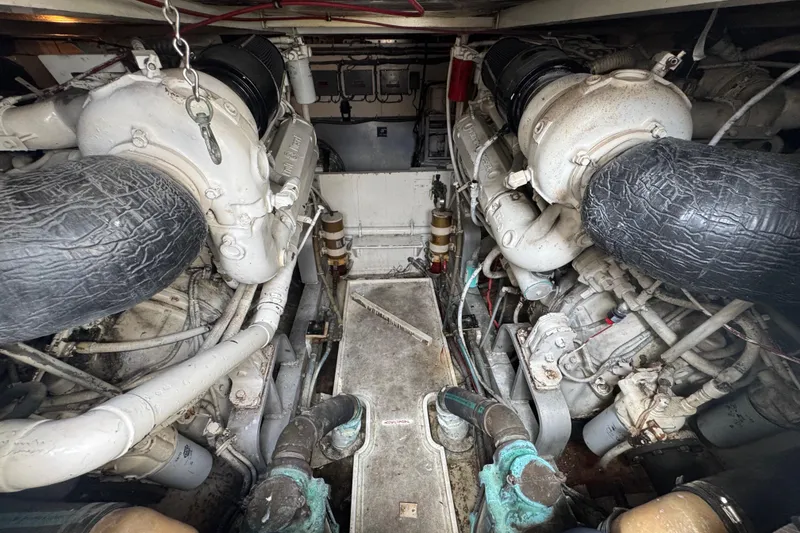 Slide: The Image of Engine room of a 1988 Bertram 50 Convertible boat, showcasing dual engines. - 13