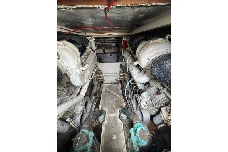 Slide: The Image of Engine room of a 1988 Bertram 50 Convertible boat, showcasing dual engines. - 14