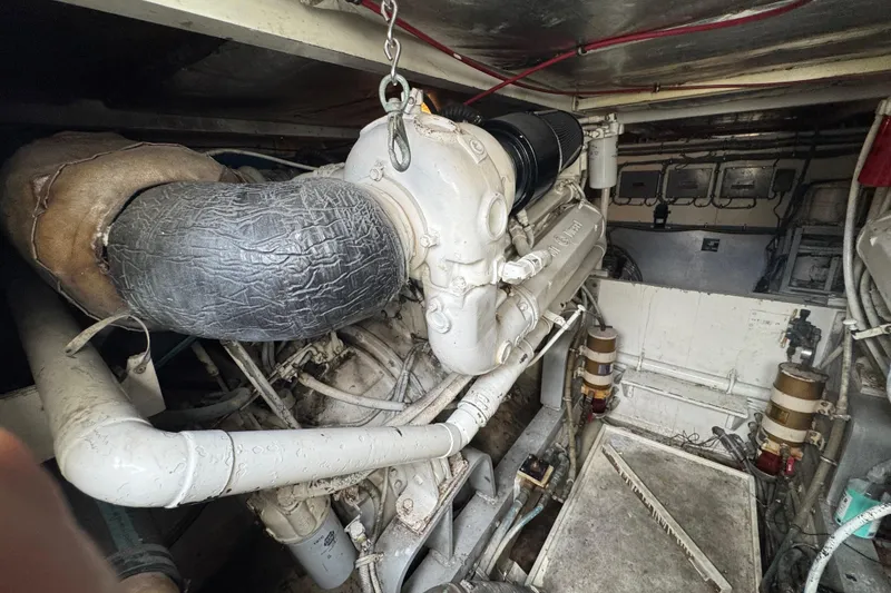 Slide: The Image of Engine room of a 1988 Bertram 50 Convertible yacht, showcasing mechanical components. - 15