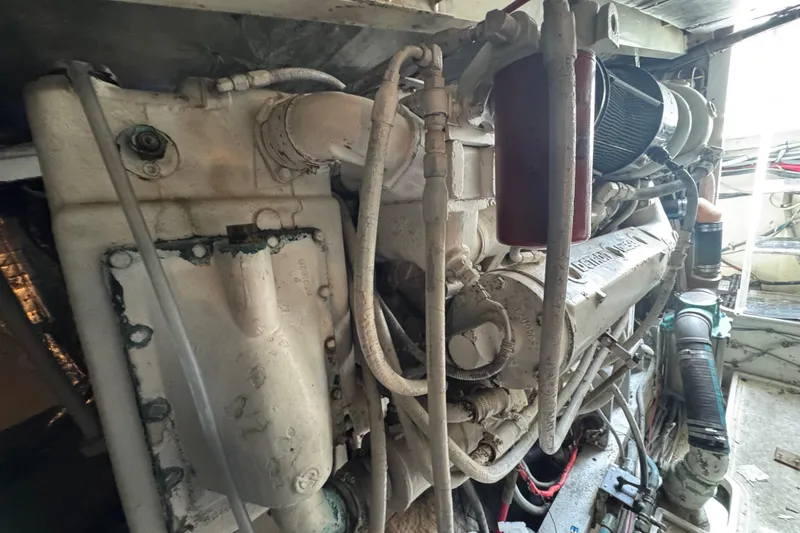 Slide: The Image of Engine room of a 1988 Bertram 50 Convertible yacht, showcasing detailed machinery components. - 19