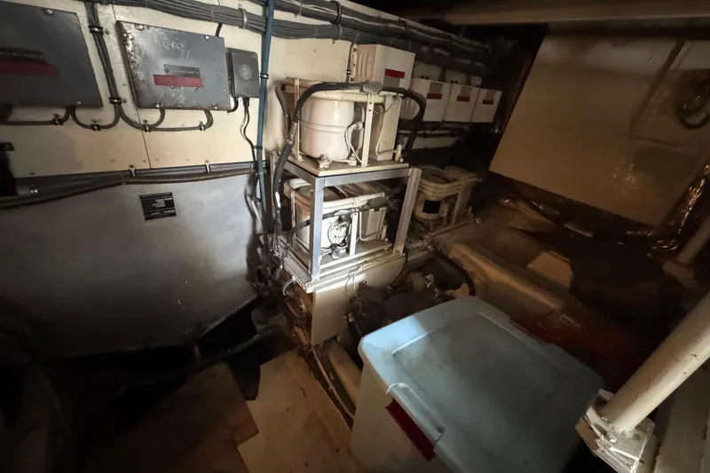Slide: The Image of Engine room of a 1988 Bertram 50 Convertible yacht, showcasing machinery and storage. - 21