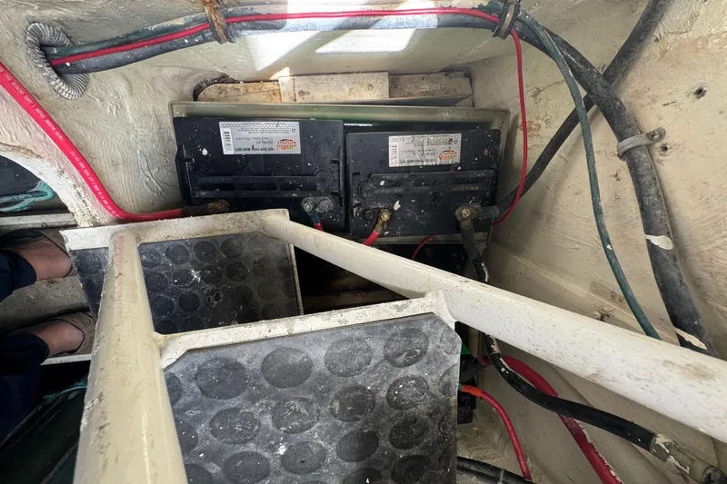 Slide: The Image of Battery compartment of a 1988 Bertram 50 Convertible boat with visible wiring. - 22