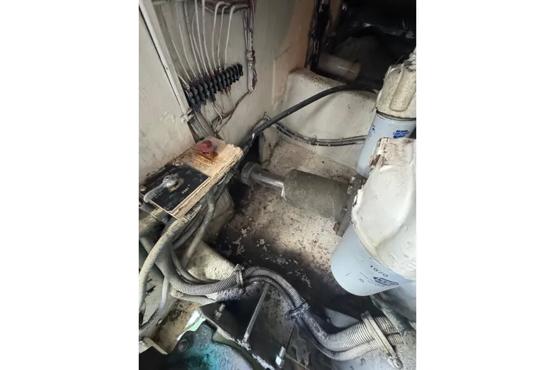 Slide: The Image of Engine room of a 1988 Bertram 50 Convertible boat, showing wiring and components. - 26
