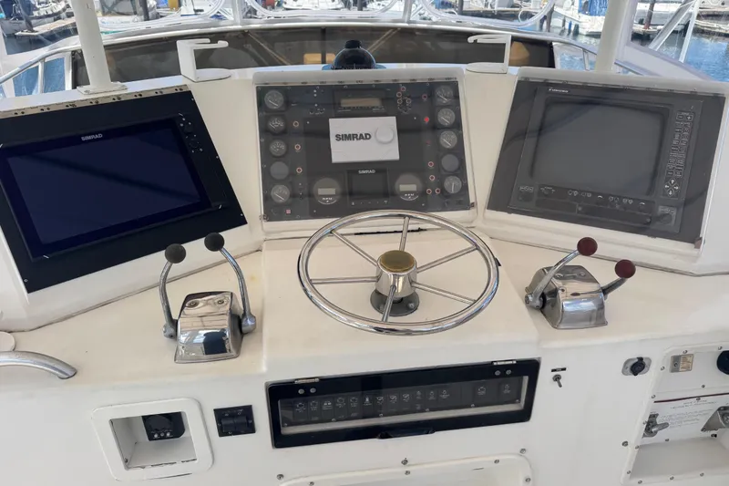 Slide: The Image of Control panel of a 1988 Bertram 50 Convertible yacht with navigation equipment. - 27