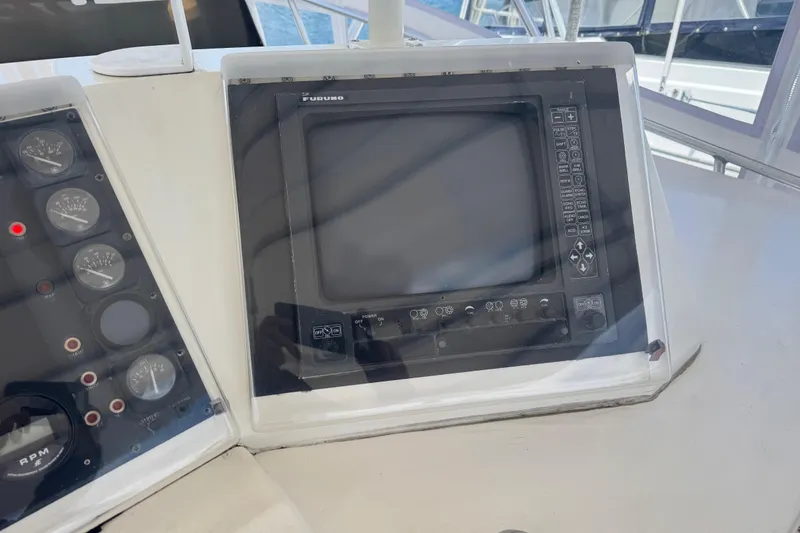 Slide: The Image of Control panel of a 1988 Bertram 50 Convertible yacht with navigation equipment. - 29