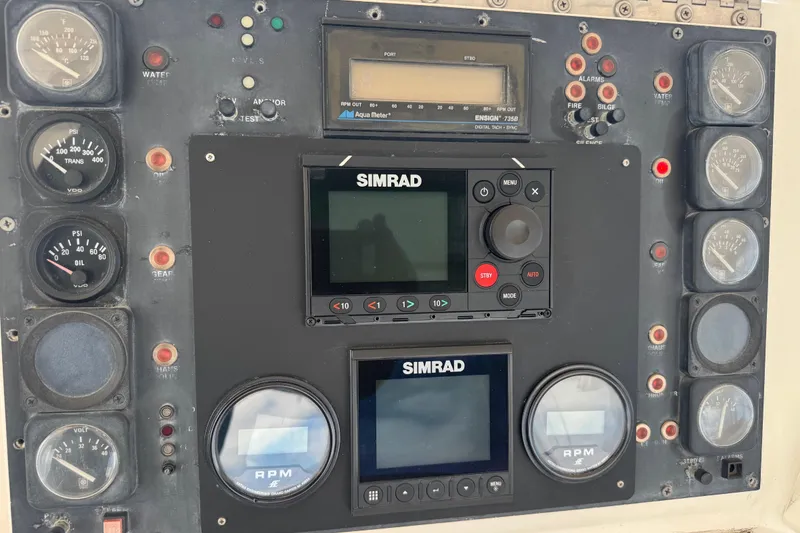 Slide: The Image of Control panel of a 1988 Bertram 50 Convertible with Simrad navigation equipment. - 30
