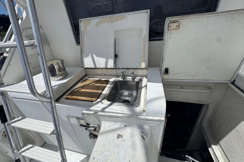Slide: The Image of Outdoor sink and cutting board on 1988 Bertram 50 Convertible yacht deck. - 31