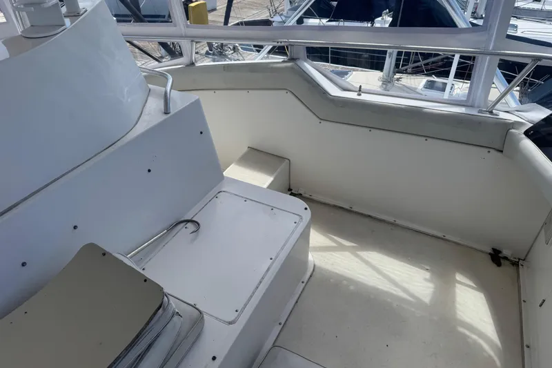 Slide: The Image of 1988 Bertram 50 Convertible yacht interior with seating and railing, showcasing spacious design. - 33