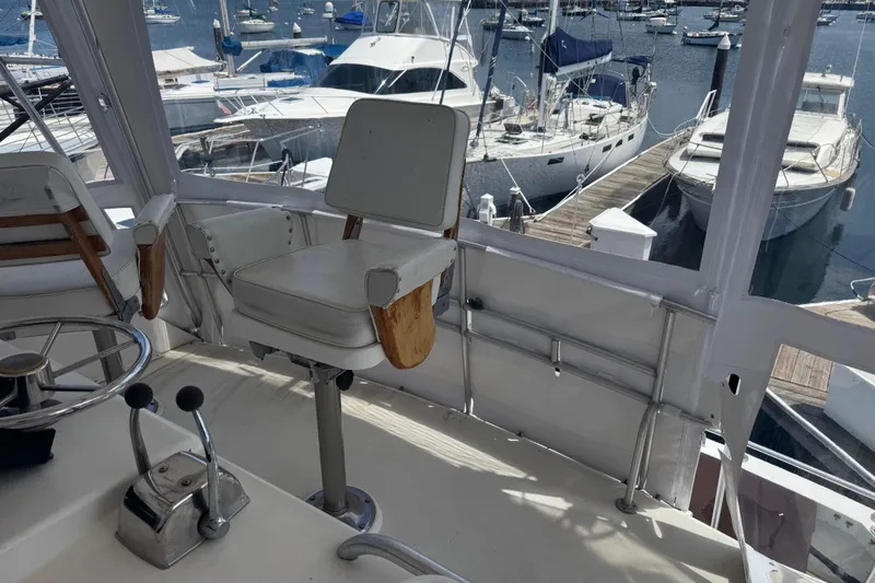 Slide: The Image of Cockpit view of a 1988 Bertram 50 Convertible yacht at a marina. - 35