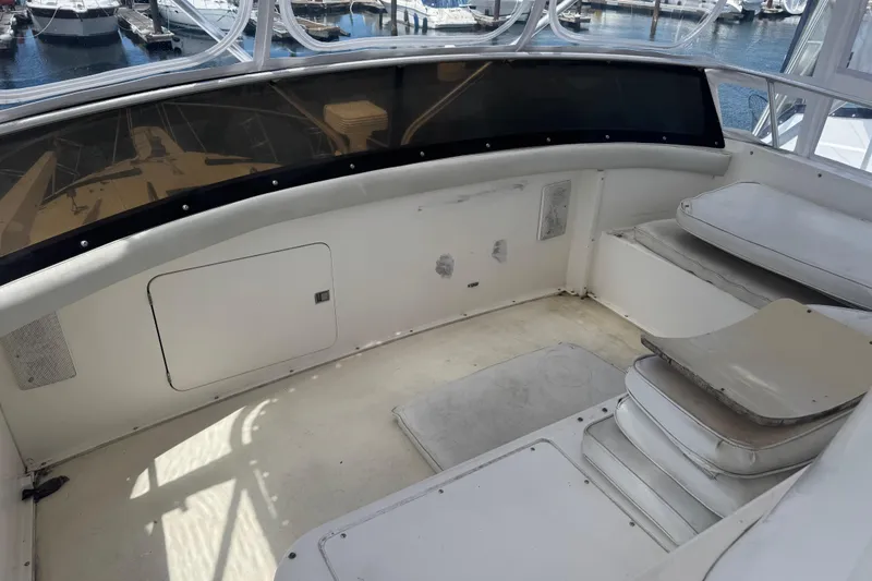 Slide: The Image of 1988 Bertram 50 Convertible boat interior with seating and storage compartments. - 36