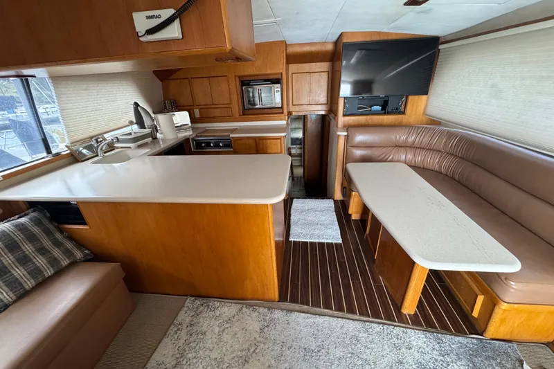 Slide: The Image of Interior of a 1988 Bertram 50 Convertible yacht with modern kitchen and seating area. - 37