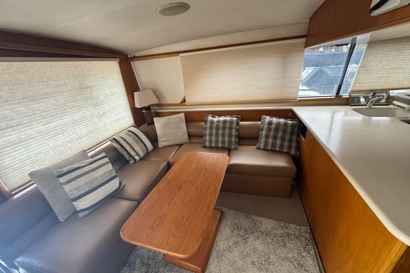 Slide: The Image of Interior of 1988 Bertram 50 Convertible yacht with cozy seating and cushions. - 38